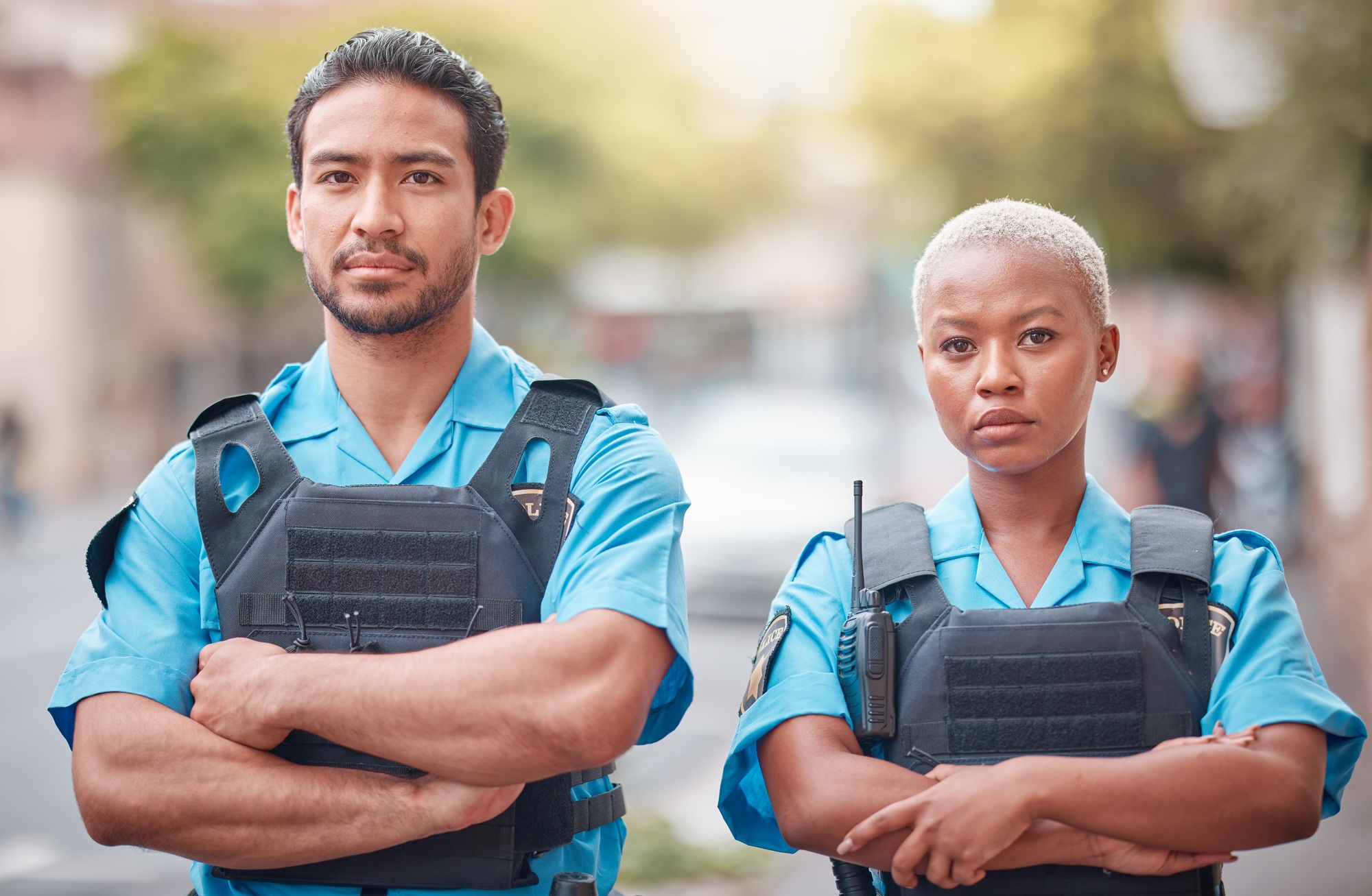 People, police and arms crossed in city for law enforcement, safety and protection outdoors. Portra